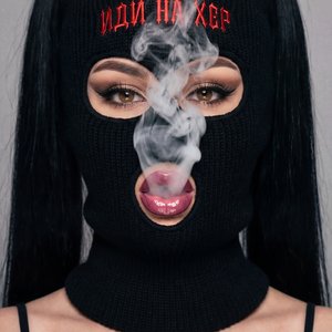 A girl captured in a close-up, high-quality professional studio portrait. She is positioned directly facing the camera in a bust-length shot. Her hands are not visible in the frame; the focus is entirely on her head and shoulders. She is blowing a cloud o
