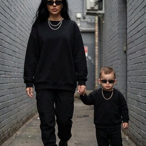 Use the uploaded photo as the exact identity reference for the people. Keep the faces identical to the uploaded image (same facial structure, skin tone, eyes, hairstyle and proportions). Recreate the same scene and composition exactly.

A stylish woman an