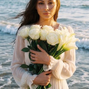 raw vogue flash portrait, waist-up female portrait standing in shallow ocean waves during golden hour, soft luxurious daylight, cinematic natural lighting, direct eye contact into camera, woman holding long-stem white flowers with both hands close to ches
