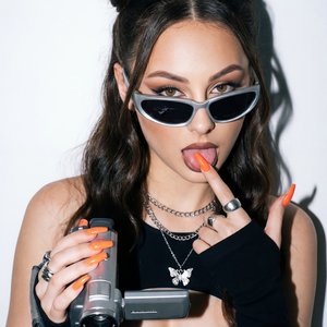 A girl captured in a trendy, playful Y2K-aesthetic portrait shot with a vintage flash photography effect.

Pose and Hands: The girl is striking a cheeky pose facing the camera.
• Right Hand: Her right hand is raised to shoulder height, firmly gripping a s