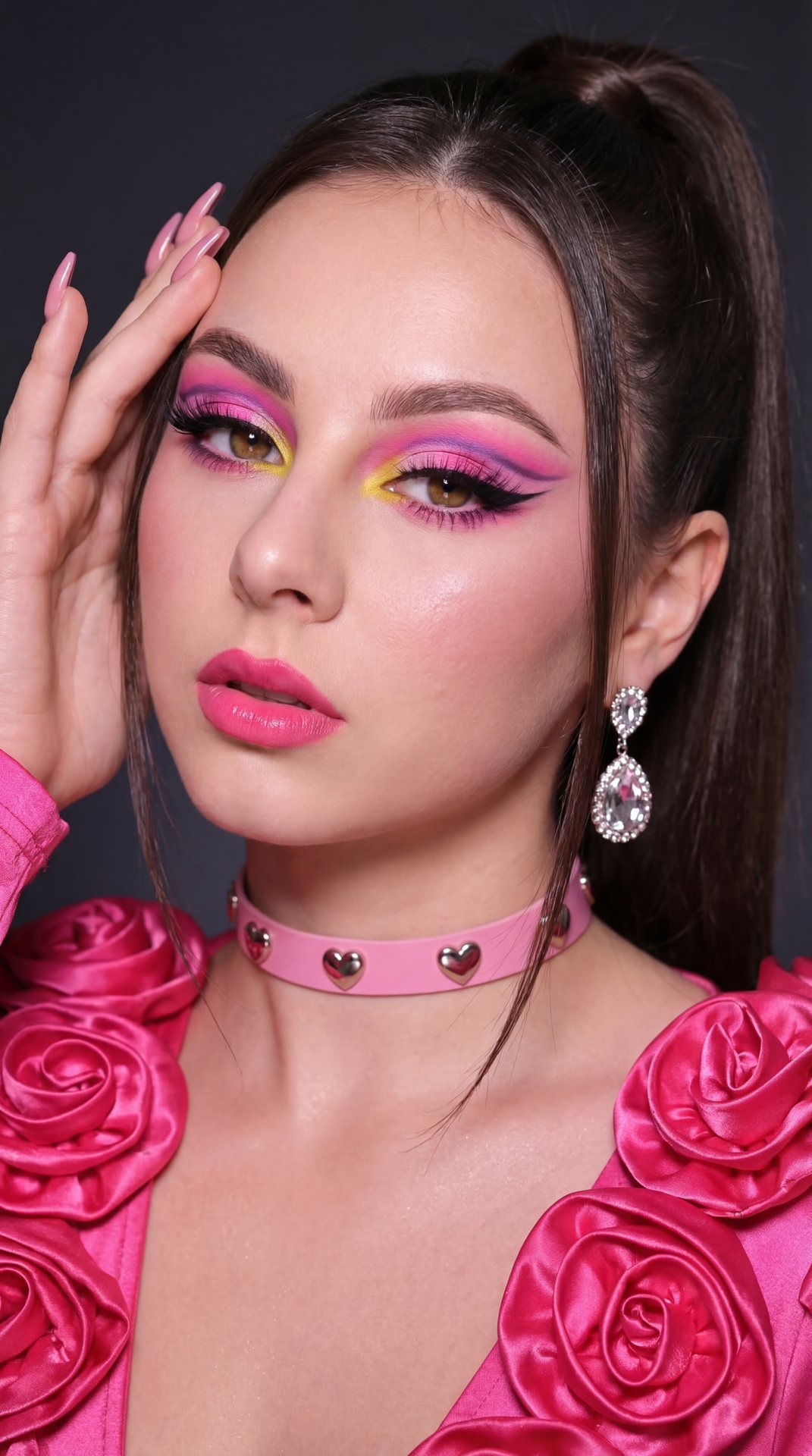A girl poses in a close-up portrait with her head tilted slightly to the left and her gaze directed firmly toward the camera, expressing a confident and intense look. Her right hand is raised to the side of her face, fingers gently resting on her temple a