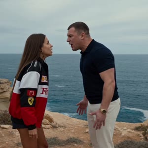 Scene structure:
0s–2s: A man(@image2) and a woman(@image1) are having a furious argument on a cliff above the ocean next to a black car. They stand facing each other at close range, yelling loudly, their faces full of anger, gestures sharp and aggressive