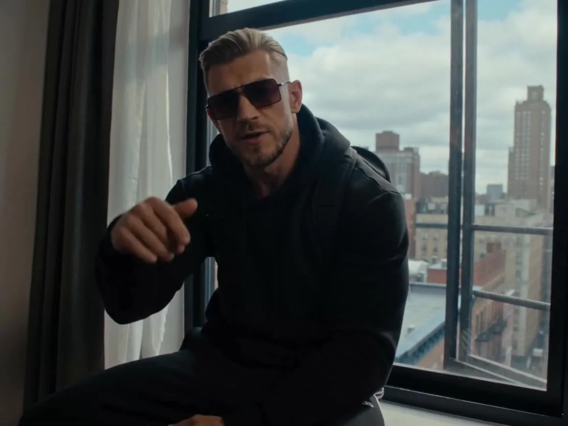 Character identity (locked — must stay identical in every frame):Real photorealistic human man as the main character, matching @image_1. Maintain his exact appearance from @image_1: exact facial features, fair/light skin tone, light brown-to-blonde hair s