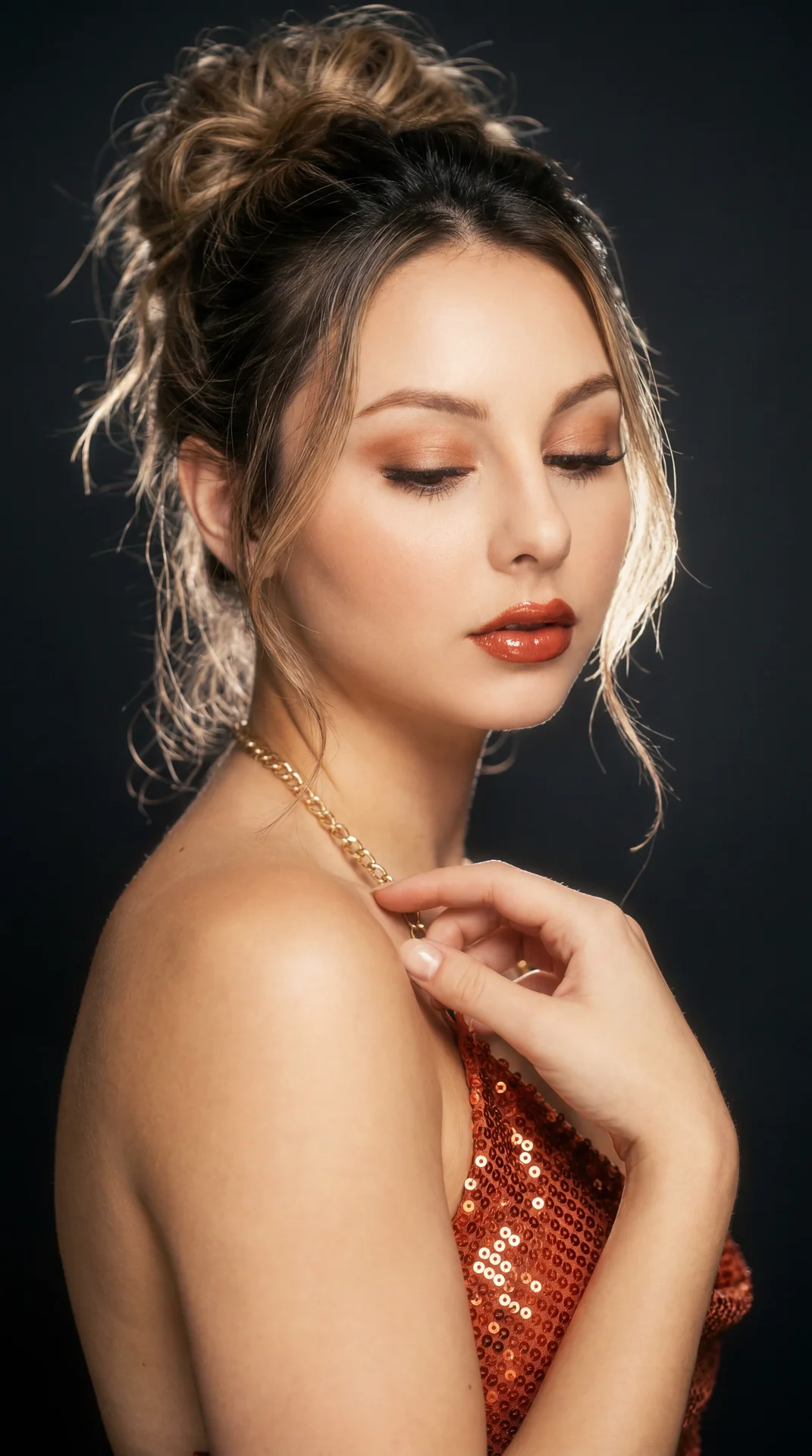 Create image: use the attached image for facial reference with high precision while preserving exact facial structure and natural asymmetry.

SCENE:
Late-90s glamour studio portrait. Subject wearing a luxurious reddish-orange sequined halter top with a wa