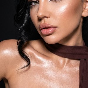 Use the face from the reference photo and preserve facial features exactly 1:1. Do not change facial proportions or identity. extreme close-up beauty portrait. Camera very close to the face, intimate framing, slightly low angle for a bold effect. Head til