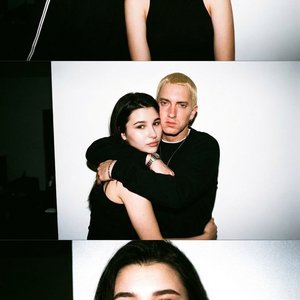 Direct on-camera flash in a dark room, blown-out white wall background, visible grain.
Frames: 1) man kissing her cheek, 2) man hugging her from behind, 3) close portrait with pout toward camera.