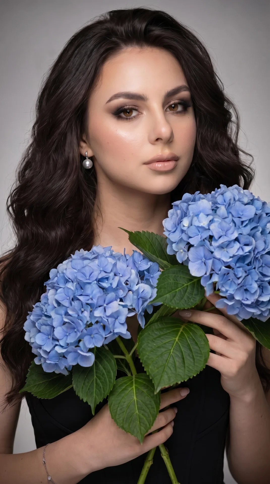 The studio portrait shows a close-up of a young woman of European descent, with her hair falling over one shoulder in soft, voluminous curls. She is looking directly at
the camera, with a gentle half-smile, showcasing her high cheekbones, which are accent