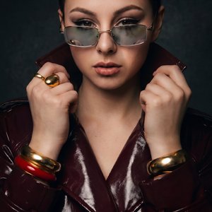 A Girl, Rembrandt lighting, classic studio portraiture, single key light at 45 degrees, subtle light triangle on cheek, dark studio background, dramatic atmosphere, fine art photography, hyper-realistic, masterpiece
