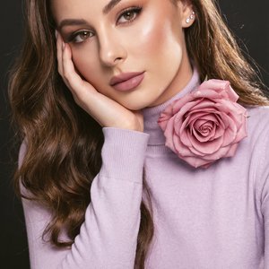 A girl — vertical professional portrait, tight medium‑close crop from upper chest to top of head, camera at eye level with a slight top‑down tilt, shallow depth of field for soft background separation.

Pose and hands:
⦁ Torso angled slightly toward the v