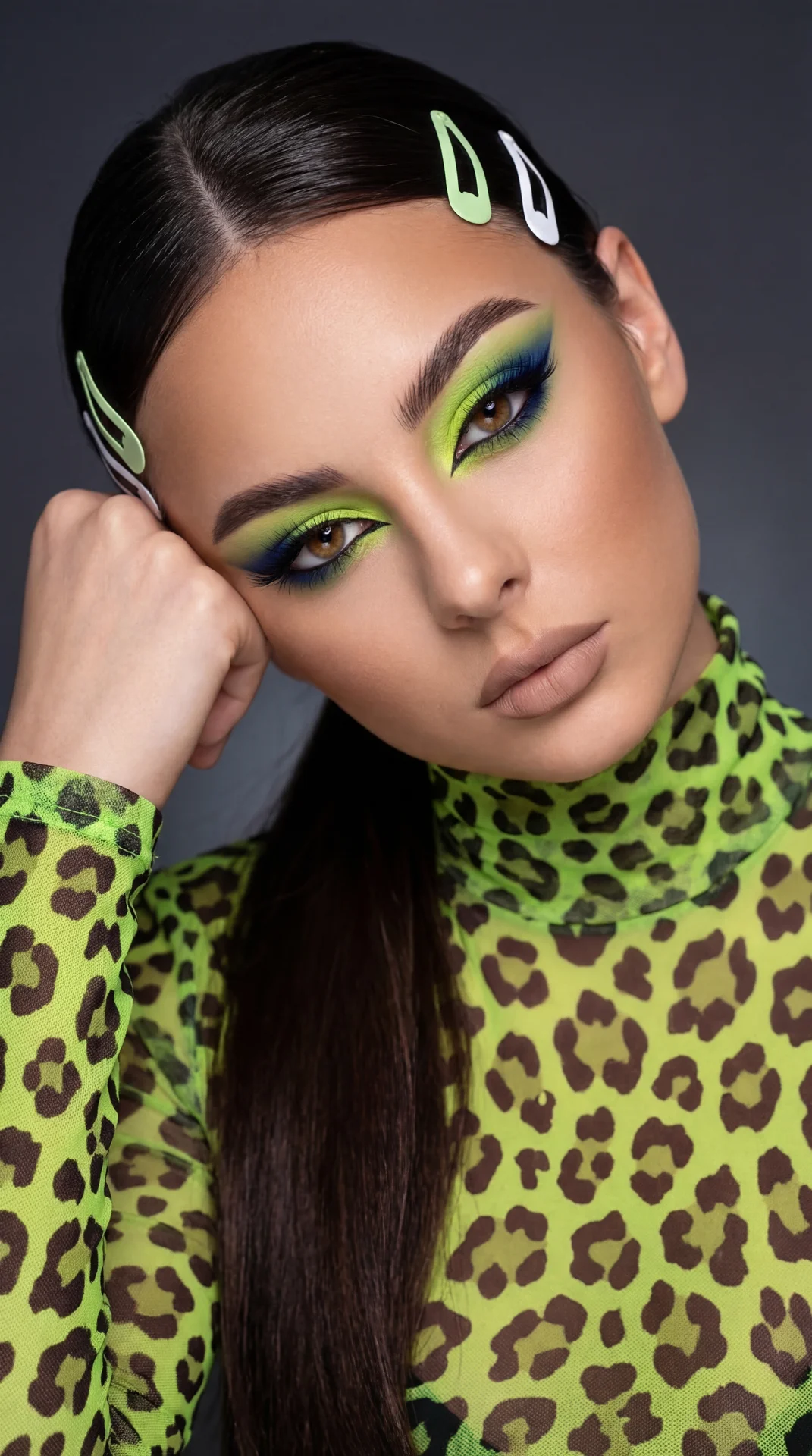 A girl captured in a high-definition professional beauty editorial close-up portrait.

Pose and Body Language: The image is a head-and-shoulders shot. She is leaning her head significantly to the side (viewer's right), resting her temple and cheekbone hea