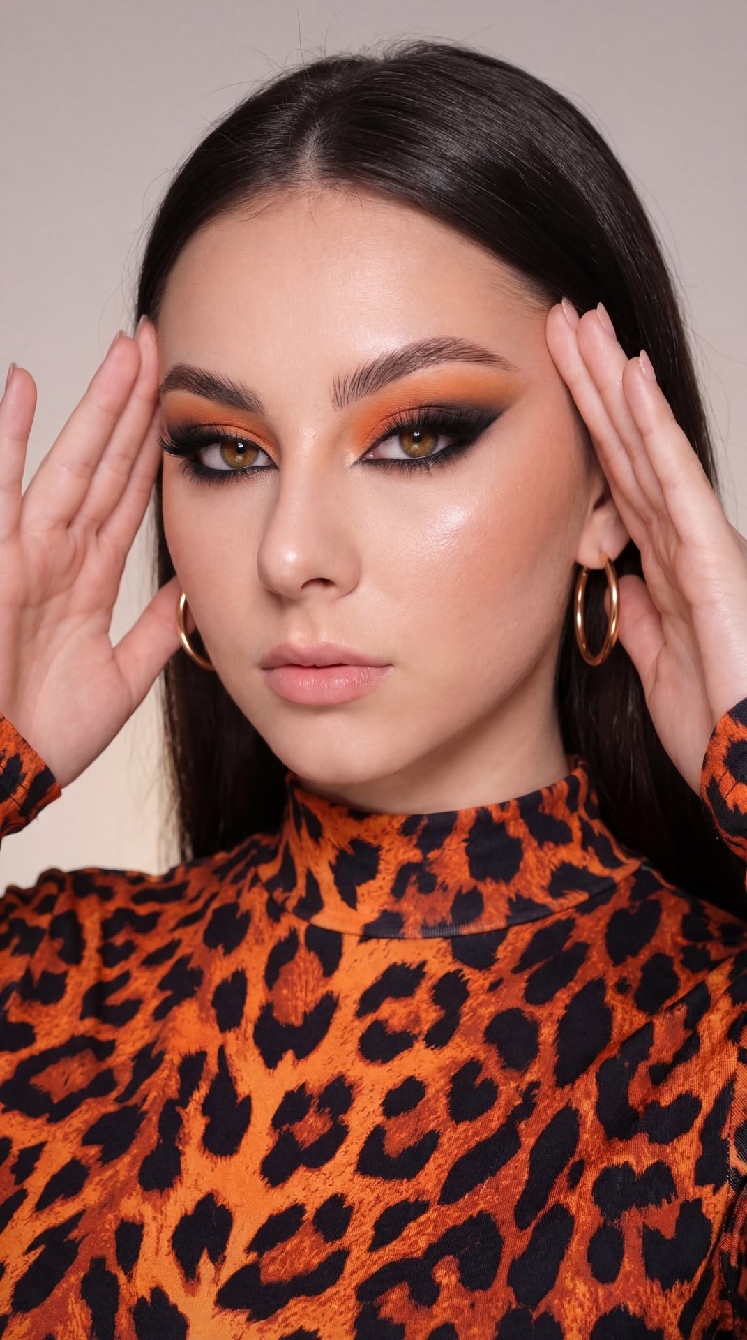 A girl is posing with her upper body, shoulders, and head framed closely in the image. She holds both hands up near the sides of her face, gently touching her temples with her fingertips spread softly, creating a framing effect around her head. Her head i
