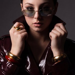 A Girl, split lighting, single side light, deep shadows on half face, high contrast, dramatic studio setup, edgy portraiture, bold and moody atmosphere, professional studio photography, 85mm lens
