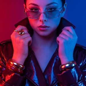 A Girl, studio gel lighting, dual color RGB lighting, red and blue gel flashes, modern editorial photography, creative studio setup, highly stylized, vibrant glowing reflections, sharp focus.