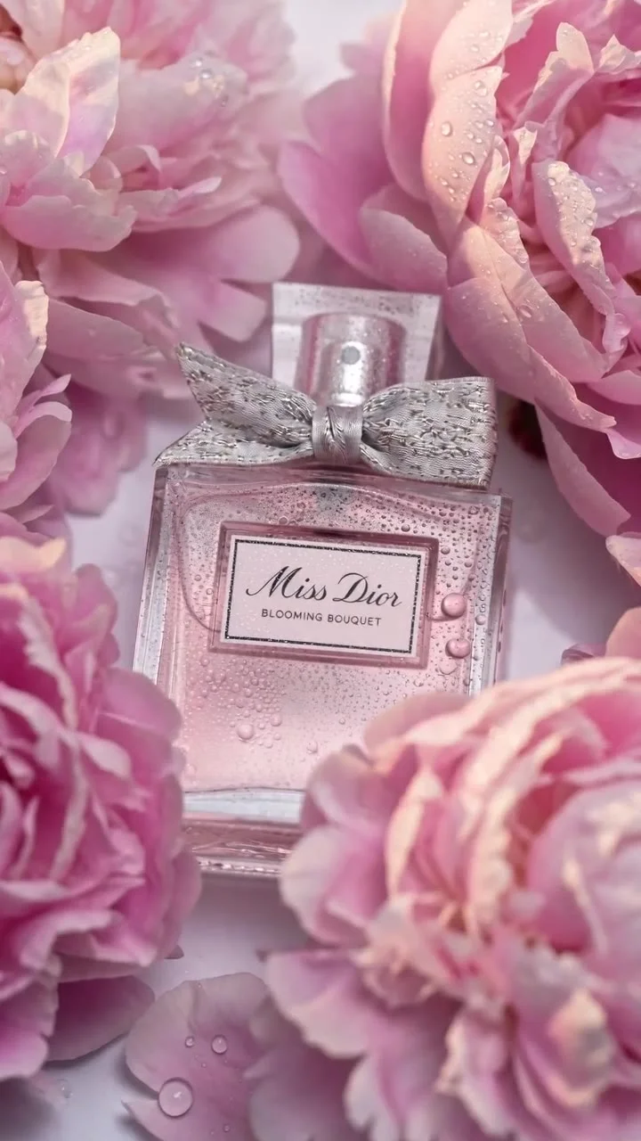 @Image1 — strict product reference for the perfume bottle, label design, glass shape, ribbon texture, liquid color, reflections and proportions. Preserve exact perfume bottle appearance throughout every shot.
@Image2 — strict identity reference for the ma